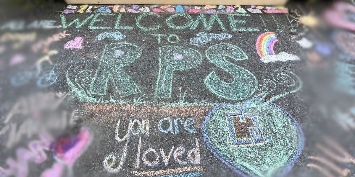Chalk art done at the front steps of Rock Point School. The art reads "Welcome to RPS (Rock Point School) You are Loved"