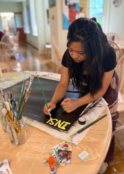A Rock Point School student works on a mood board project in the common room. 