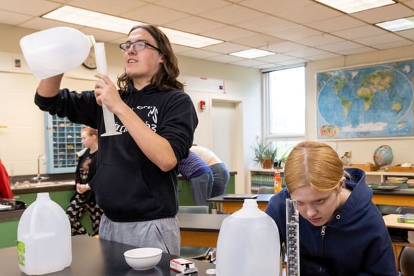 Two students conduct a science experiment together in class at Rock Point School. 