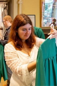 A Rock Point School senior student inspects their graduation gown after receiving it the night before the ceremony.