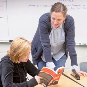 Teacher works with student