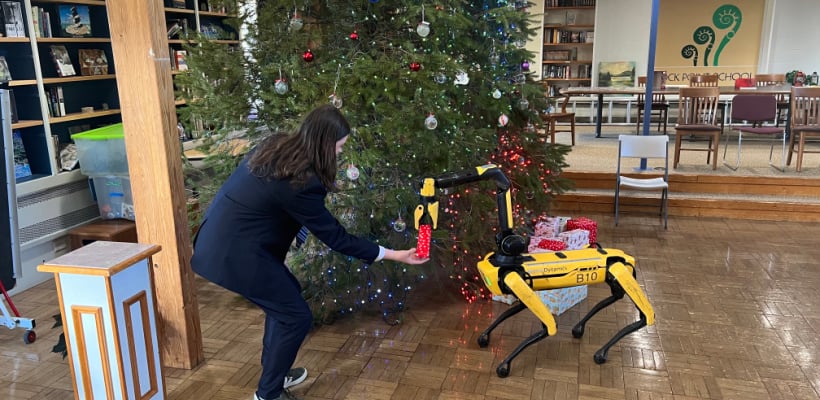 Spot the Robot hands out gifts under the Christmas tree