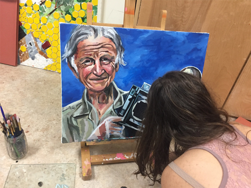 Student Painting a Photographer