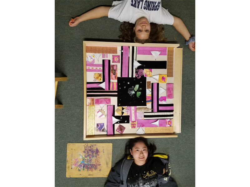 Students with art on the floor