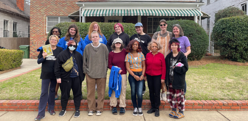 Group of students and adults pose in front of the Harris House in Montgomery, AL with Velma Harris